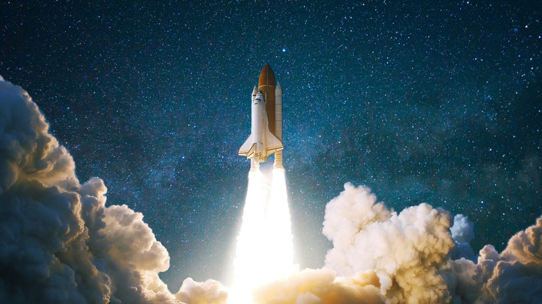 A space shuttle flying up to space