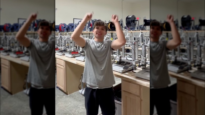 Mike Satterlee posing in front of his 3D printers.
