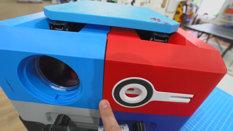 Unnecessary Inventions showing the damage to his 3D-printed suitcase