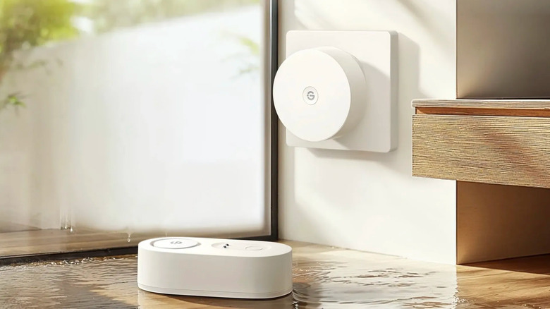 The GoveeLife water leak sensor beside the gateway plugged into the wall by a window.