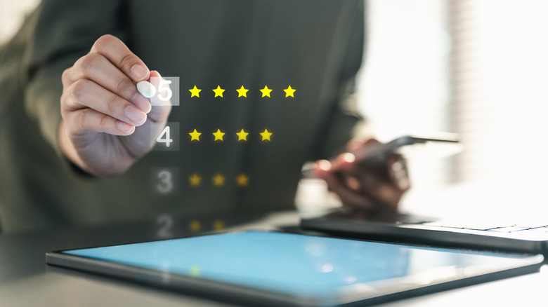 Customer review concept showing a person tapping a 5 star graphic