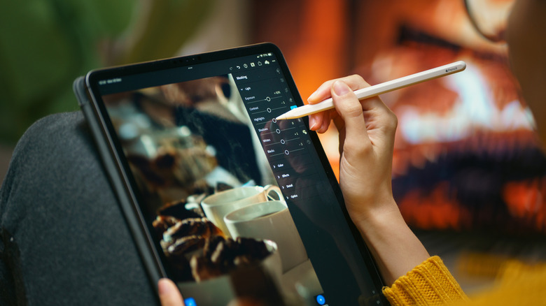 Person editing photo on tablet with stylus