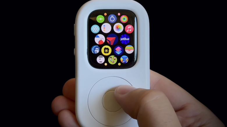 A person using an Apple Watch as part of the tinyPod device.