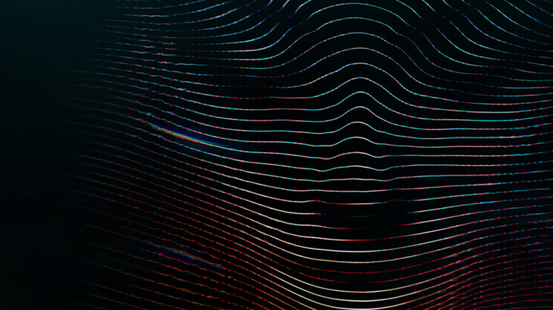 Wavy horizontal lines forming the shape of a face on a dark background, with a subtle rainbow edge glow.