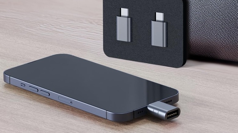 Syntech USB adapter plugged into an iPhone on a desk