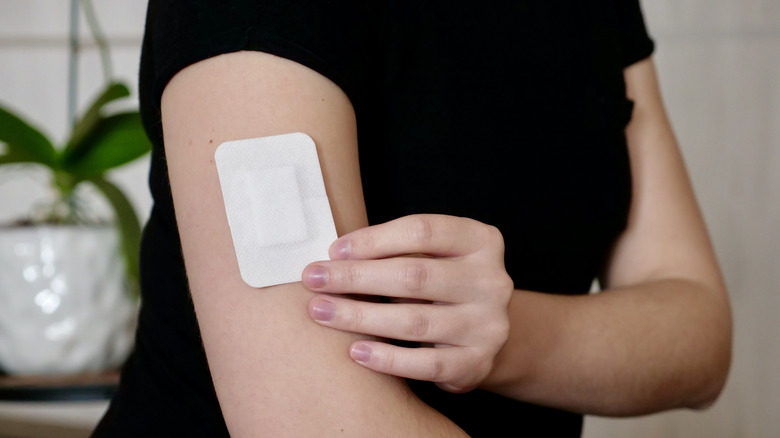 a woman's arm with a wearable skin patch