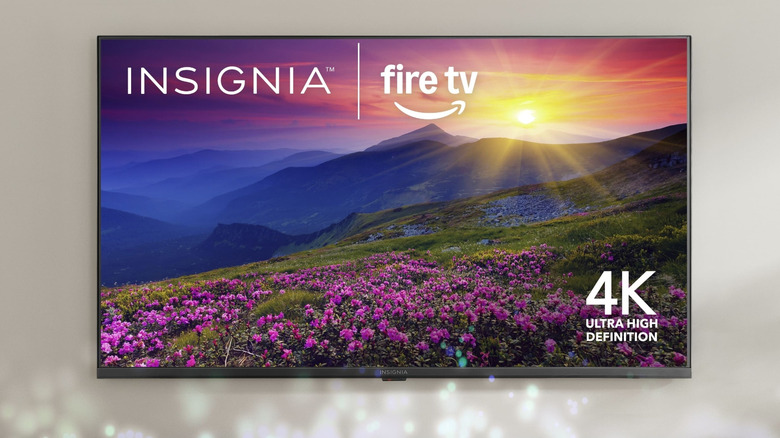 The Insiginia F50 mounted to a wall with the company and Fire TV logo on the homescreen