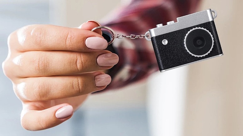 Vivitar retro-inspired keychain camera held by user.