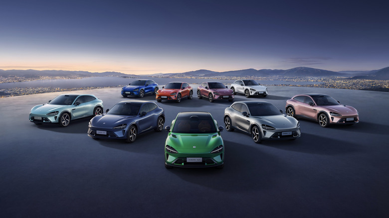 The Xiaomi YU7 electric vehicle lineup on a tarmac against a mountainous background.