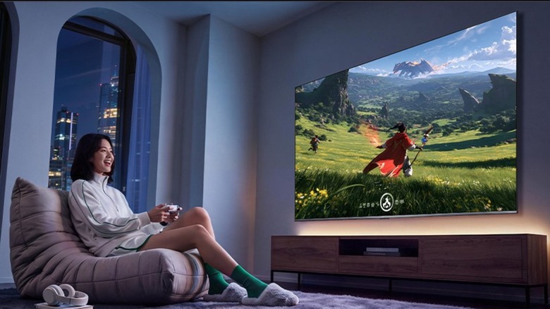 Woman playing a video game on the Xiaomi Redmi 55" RGB Mini LED Smart TV
