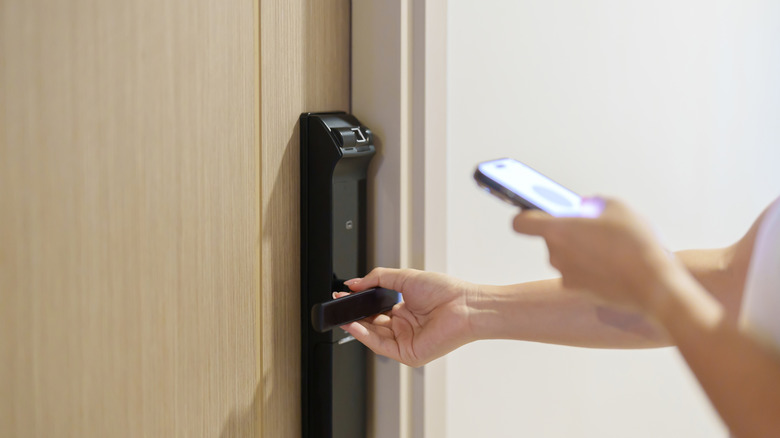 Opening a hotel door with a mobile keycard.