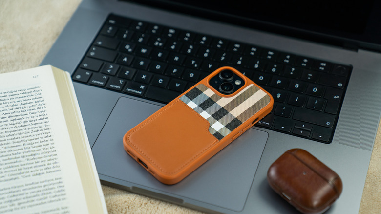 a phone with a case on it sitting on a laptop