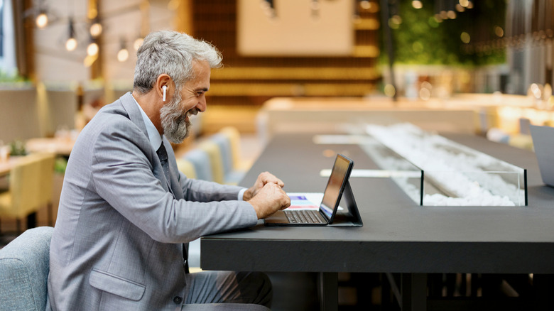 A person using AirPods in a public setting.