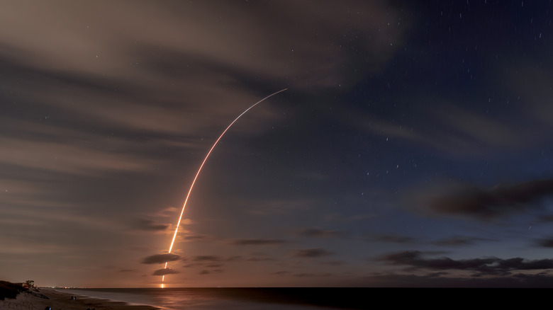 trail across sky from rocket launching into space