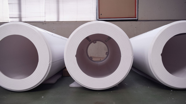 Three hollow cylindrical rods that are part of bladeless wind turbines