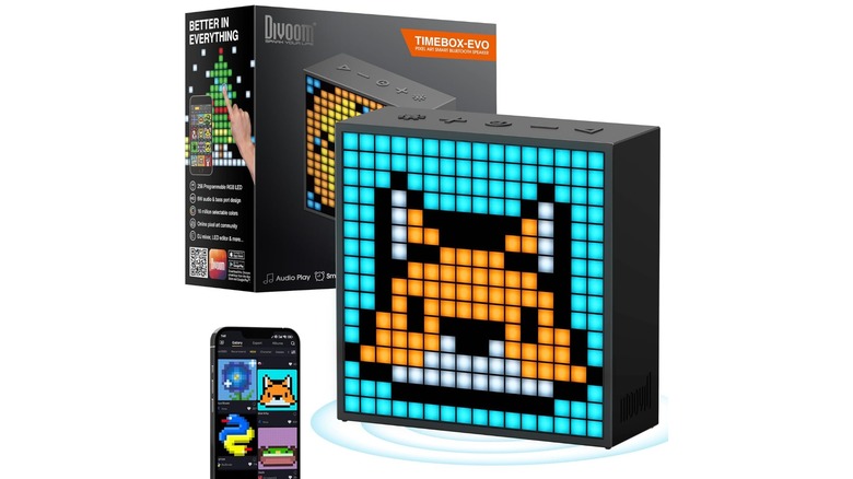 An Amazon promotional photo for the Divoom TimeBox Evo Pixel Art Bluetooth Speaker, the image showcases the device, its box, and the accompanying app on a smartphone