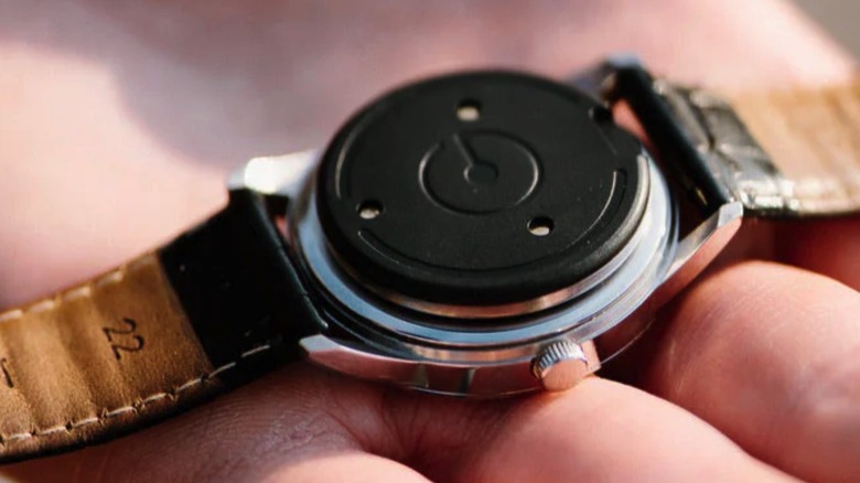 The Heir attached to the back of a watch.