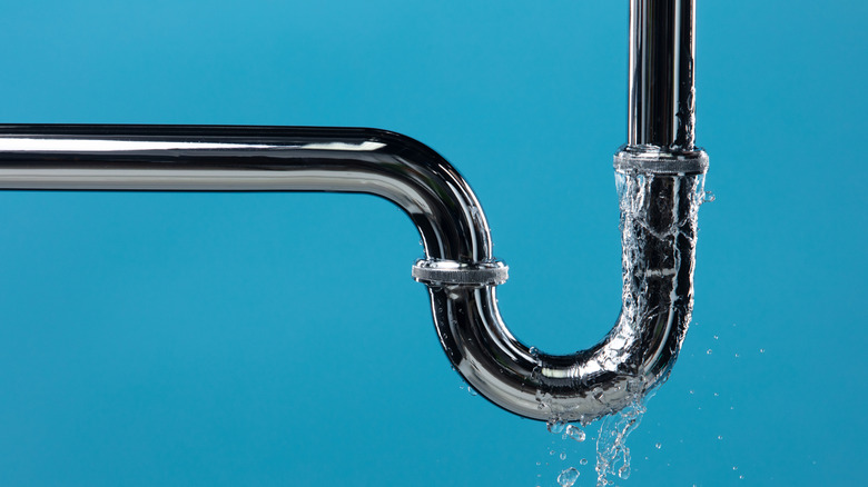 A steel pipe leaking water.