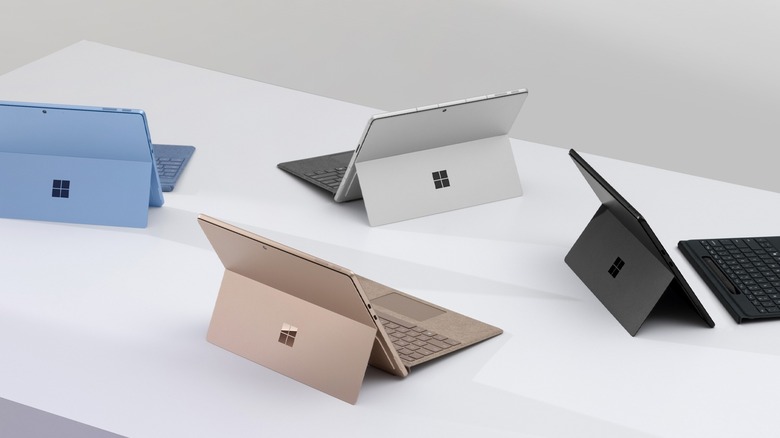 Microsoft Surface Pro laptops in different colors on a white surface