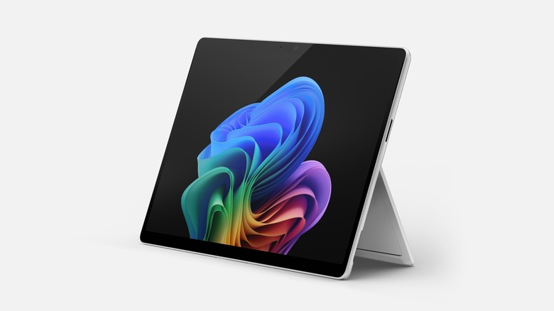 The Microsoft Surface Pro propped up using the stand against a grey background