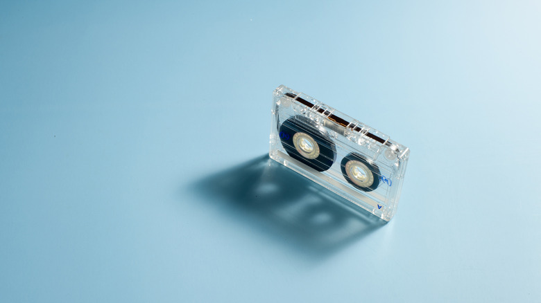 A single audio cassette tape on a blue background