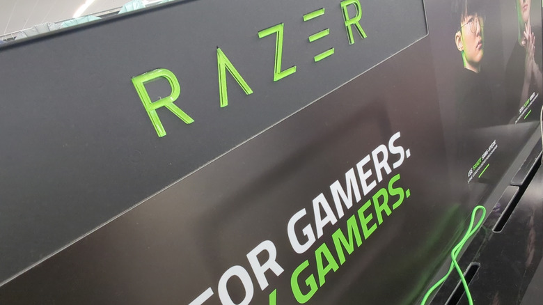 A Razer retail sign that says for gamers, by gamers