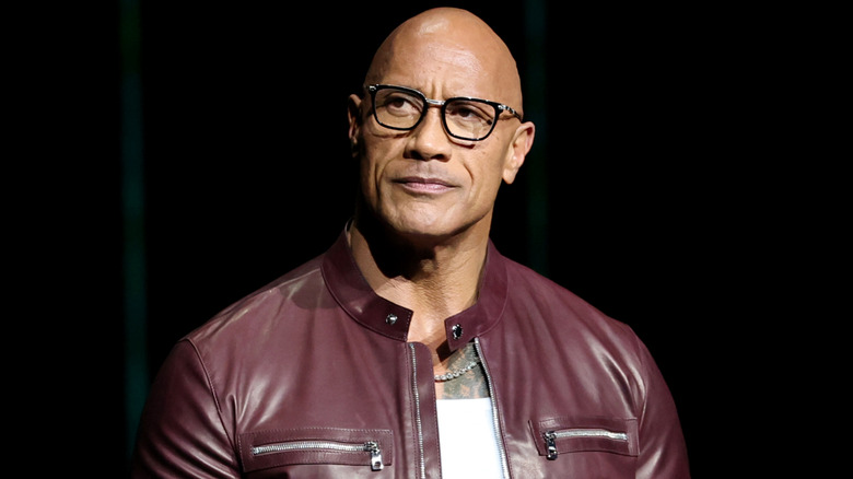 Dwayne Johnson looking to the side at an event