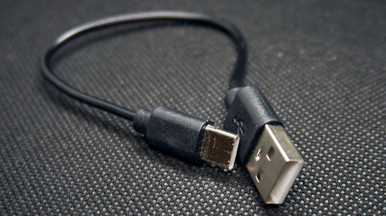 a black USB cable with one USB-A connector on side and USB-C on the other