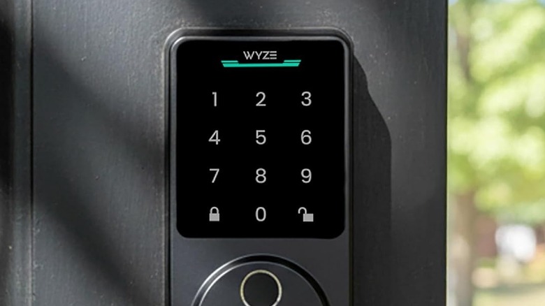 The Wyze Auto-Lock Bolt v2 keypad mounted to a gray door.