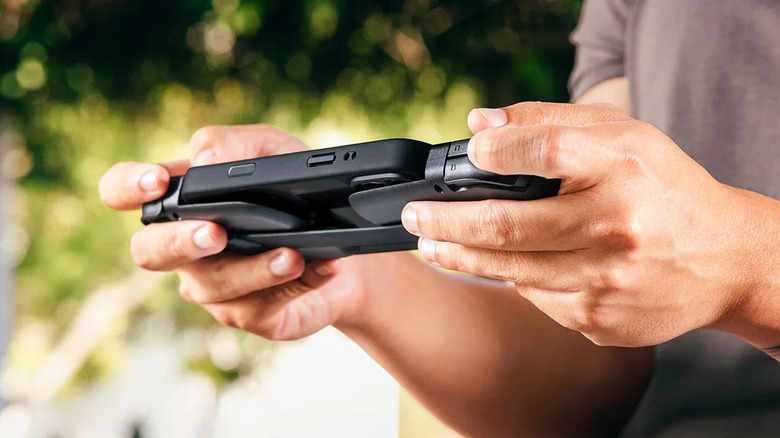 Man holds Razer Prio in outdoor area