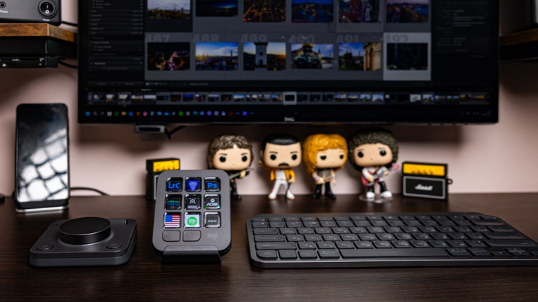 Logitech peripherals on a desk with a monitor and decor in the background.