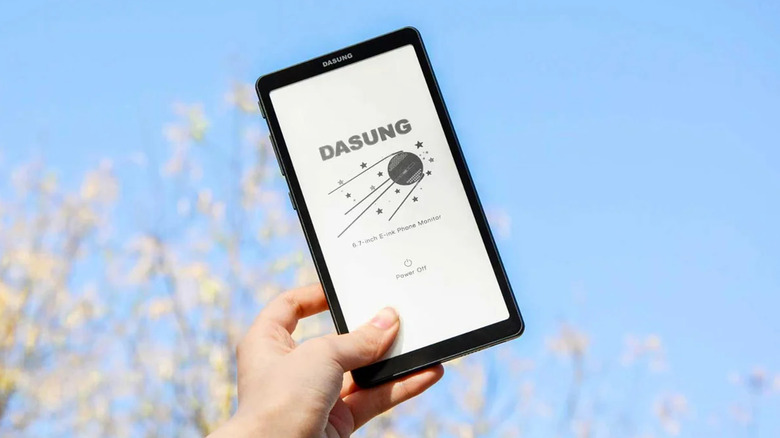 A person holding a Dasung 6.7 inch E-Ink display