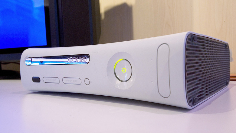 Original Xbox 360 console on a table in front of a TV