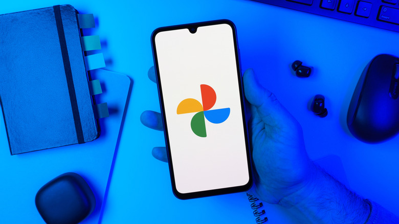 Smartphone showing Google Photos logo on desk