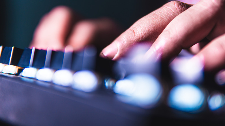 Close up of fingers pressing buttons on a mechanical keyboard.