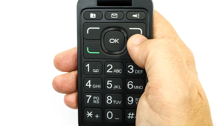 A close-up of the keypad of an old flip phone.