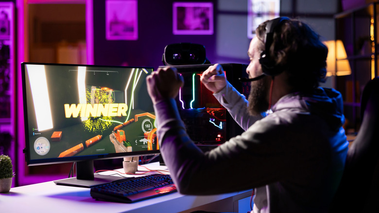 Gamer playing on PC with "Winner" on screen.