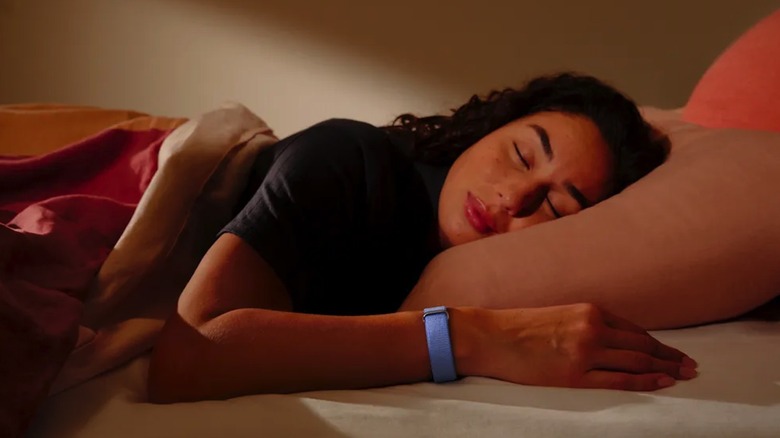 A person sleeping while wearing the Fitbit Air health tracker.