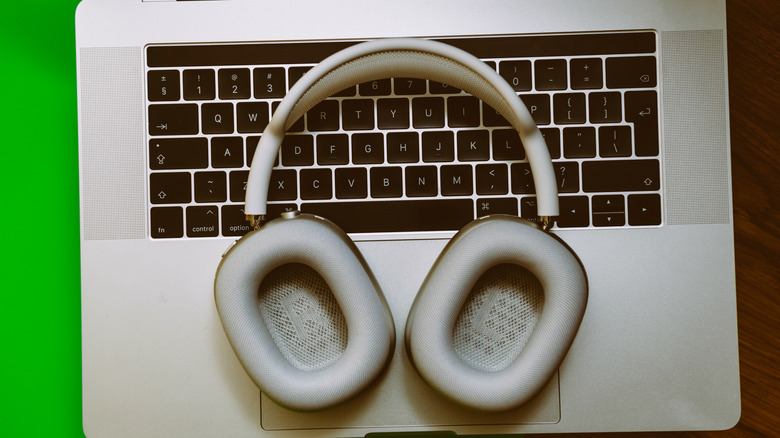 The AirPods Max resting on top of a laptop keyboard.