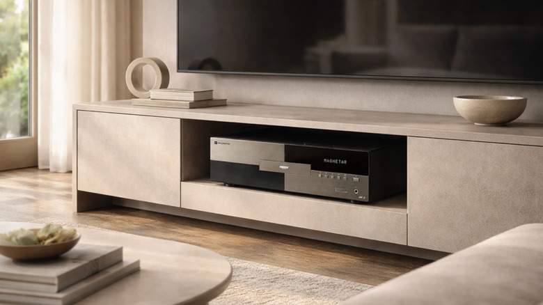 A Magnetar media player set up in a modern living room below a wall-mounted TV.
