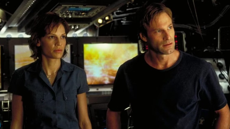 Major Rebecca Childs and Dr. Joshua Keyes standing next to each other and listening