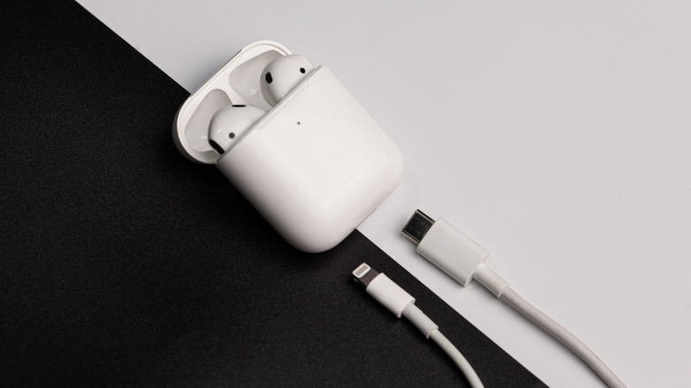 AirPods charging case open with unconnected charging cables