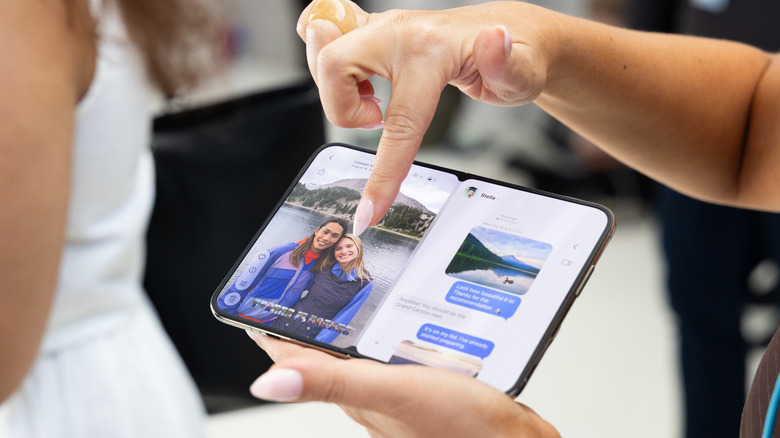 An open iPhone Duo with a photo on one side and messages on the other