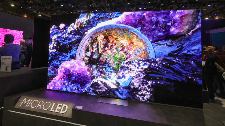 Attendees look at the world's first transparent MicroLED display at the Samsung booth during CES 2024