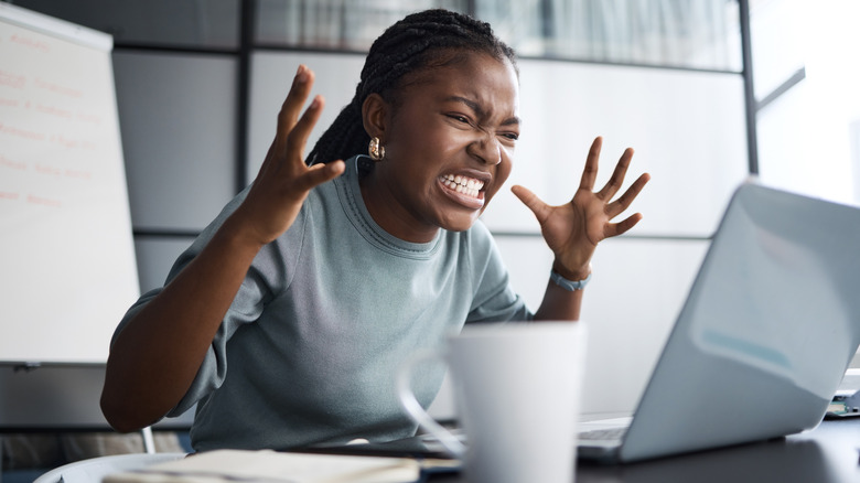 a woman angry at her computer