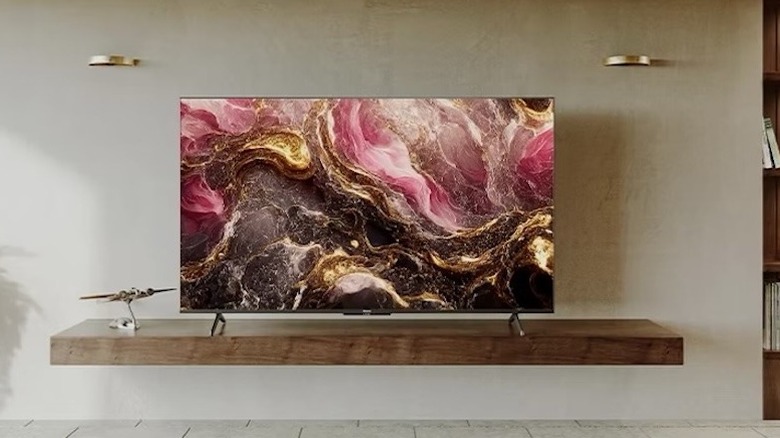 A Hisense TV set up on a floating TV stand in a living room.