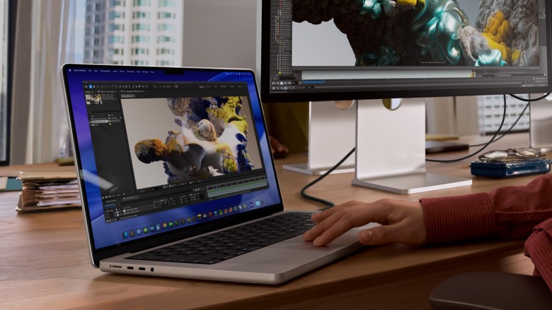 Apple MacBook Pro on a table with a connected monitor