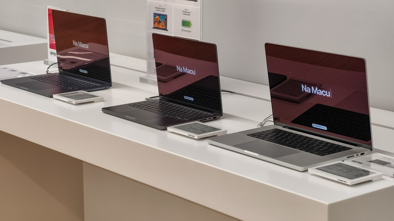 Interior of an Apple authorised reseller store with MacBooks on display