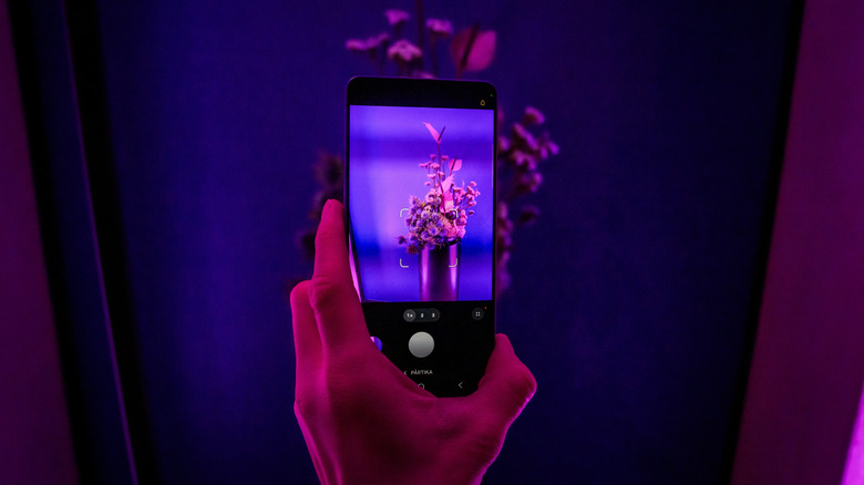 close-up of someone holding a Galaxy S26 smartphone with the camera app open