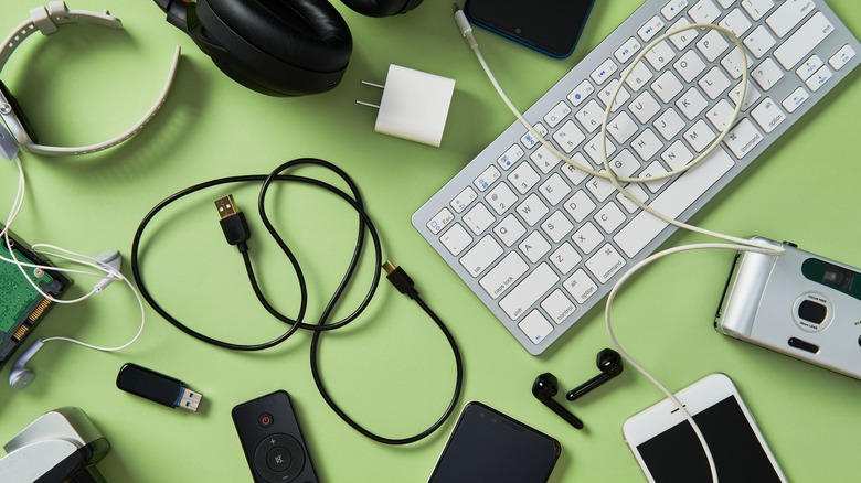 a bunch of tech gadgets on a green backdrop